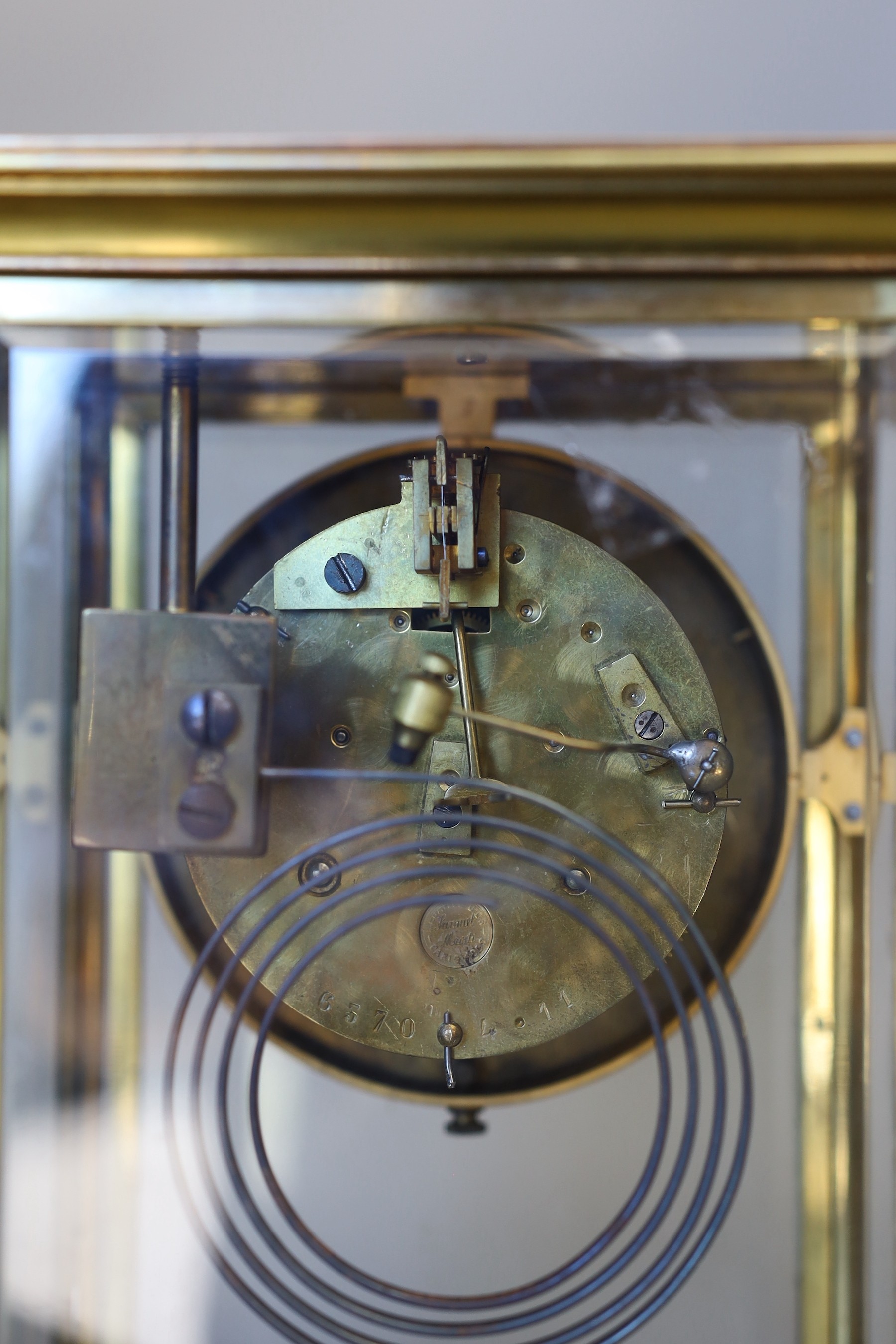 A 19th century French four glass mantel clock, with key and pendulum, 27cms high